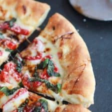 Green Olive Pesto Pizza with Feta Stuffed Crust, Roasted Red Peppers and Balsamic Drizzle