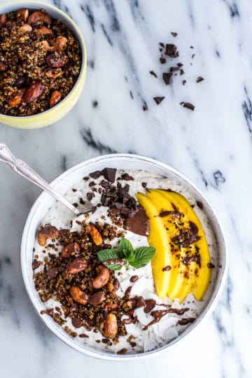 Coconut Banana Oats Bowl with Crunchy Black Sesame Quinoa Cereal + Mango.