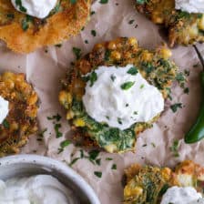 Spinach and Artichoke Corn Fritters with Brie and Sweet Honey Jalapeño Cream.