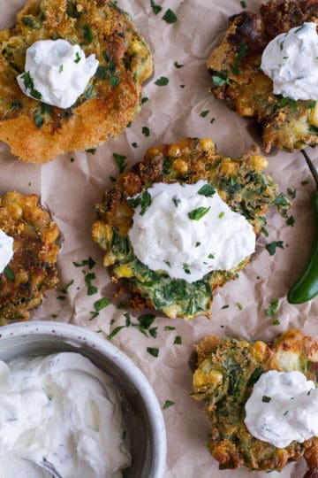 Spinach and Artichoke Corn Fritters with Brie and Sweet Honey Jalapeño Cream.