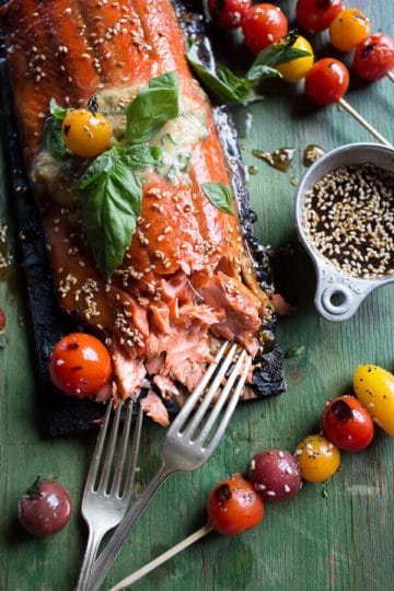 Cedar Plank Grilled Sesame Salmon with Kimchi Miso Butter and Grilled Tomatoes.