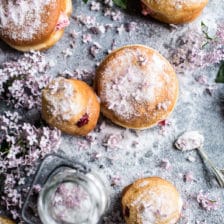 Strawberry Jelly and Vanilla Cream Brioche Doughnuts with Lilac Sugar.