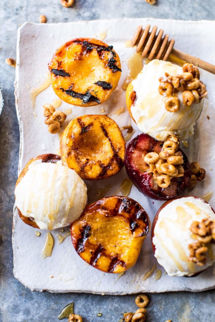 overhead photo of Cinnamon Grilled Peaches with Mascarpone Ice Cream on plate with honey drizzler