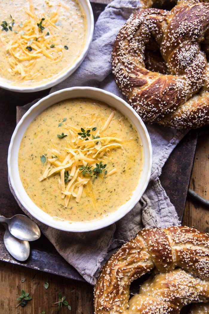 overhead photo of Pumpkin Beer Broccoli Cheddar Soup in bowl with pretzels on plate