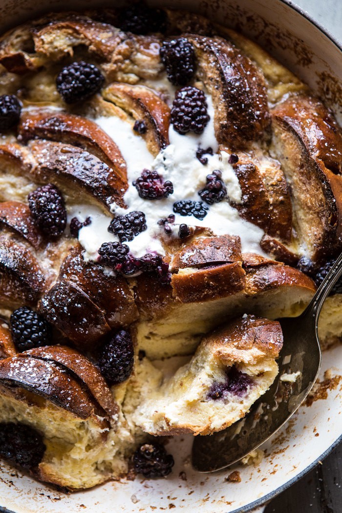 overhead photo of cut into Baked Blackberry Ricotta French Toast with bite out