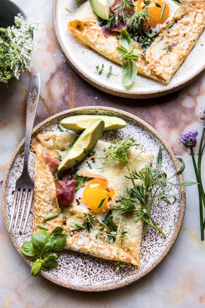 overhead photo of Baked Egg Crepes with Spring Herbs and Avocado with two plates