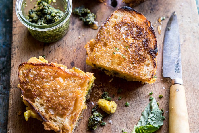 horizontal angled photo of Breakfast Grilled Cheese with Soft Scrambled Eggs and Pesto