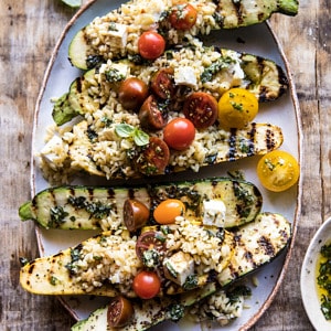 Grilled Pesto Zucchini Stuffed with Tomatoes and Orzo | halfbakedharvest.com #grilling #summer #easyrecipes