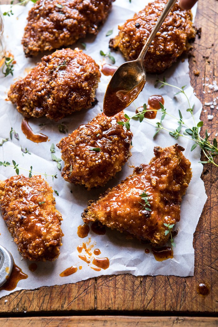 adding sauce to Oven Fried Southern Hot Honey Chicken 