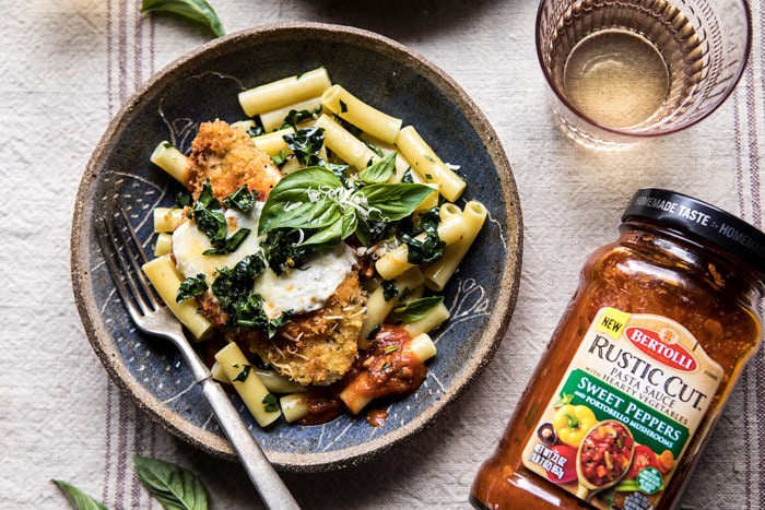horizontal photo of Spring Chicken Parmesan with Tuscan Kale Pesto with pasta sauce