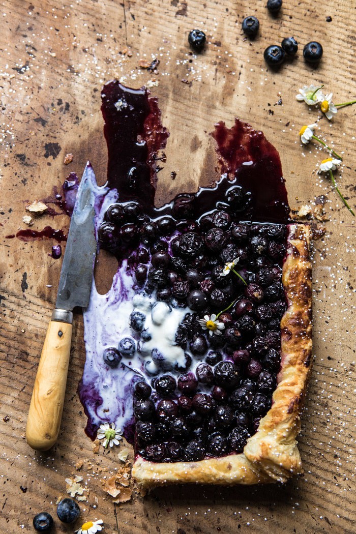 overhead photo of cut into Blueberry Chamomile Galette with knife in photo