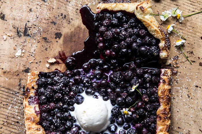 horizontal overhead photo of Blueberry Chamomile Galette with slice missing 
