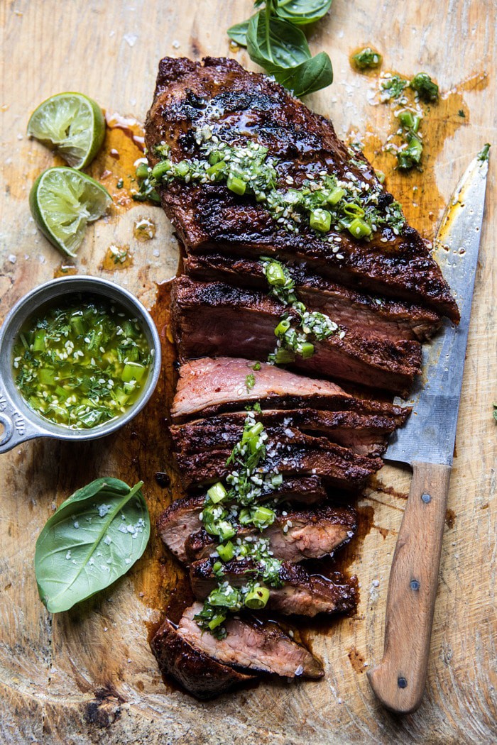 overhead photo of Korean Grilled Steak with Toasted Sesame Chimichurri with knife