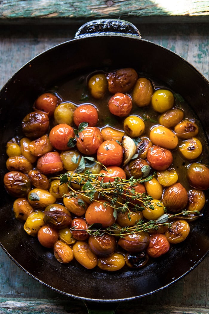 overhead photo of burst cherry tomatoes in skillet