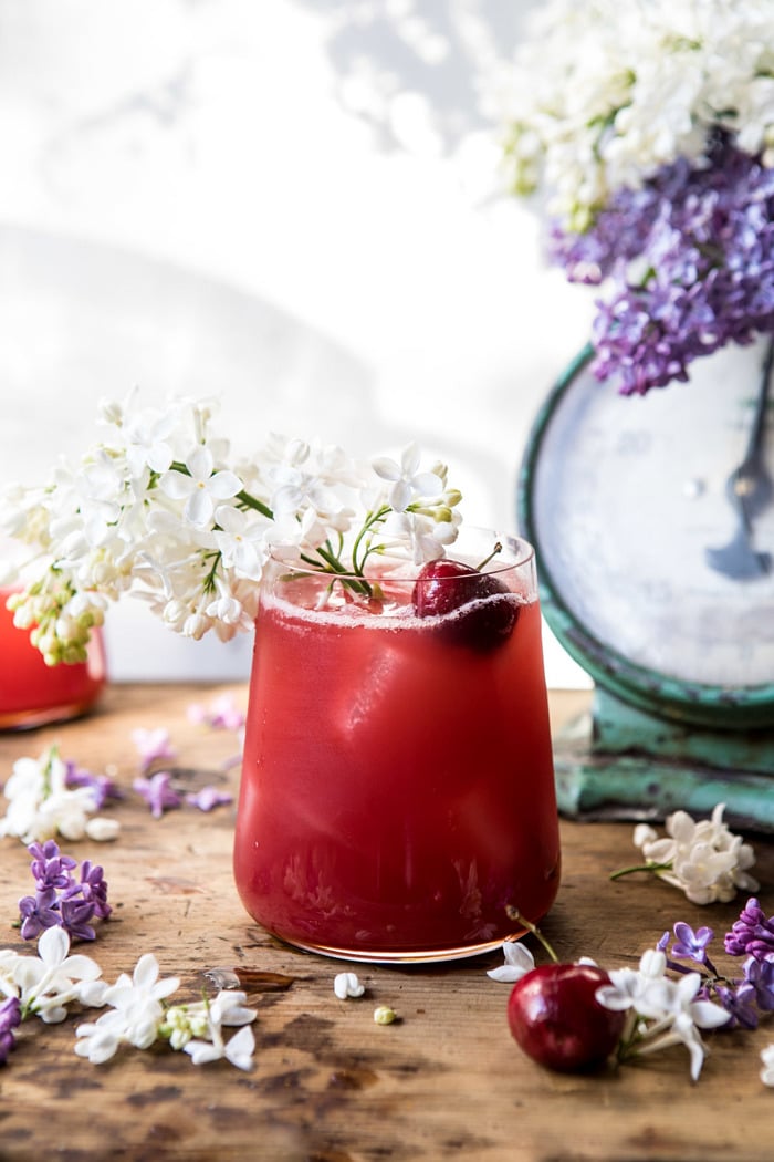 front on, close up photo Hibiscus Cherry Vodka Spritz with lilacs