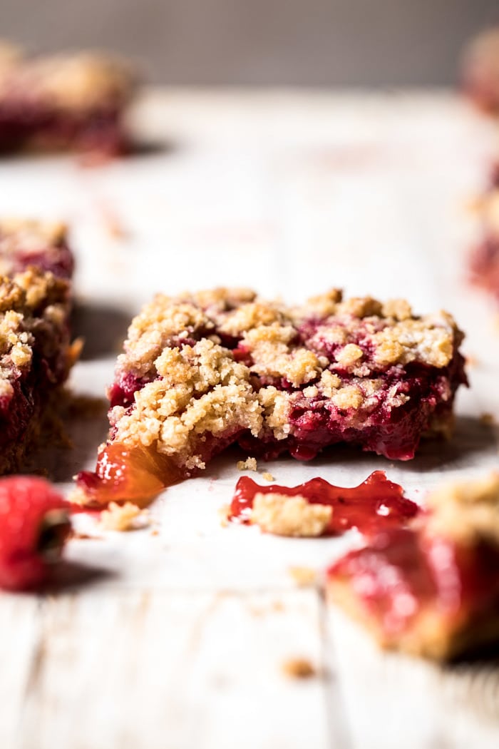 Buttery Raspberry Crumble Bars broken in half to show the filling 