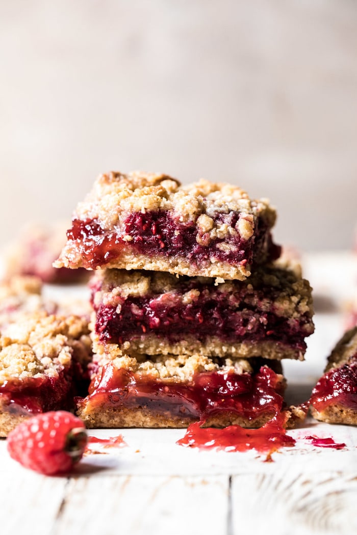 Buttery Raspberry Crumble Bars stacked on top of each other