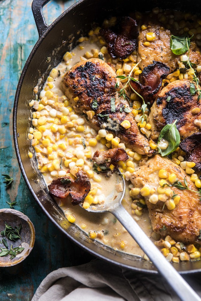 Garlic Butter Creamed Corn Chicken with spoon and extra sauce