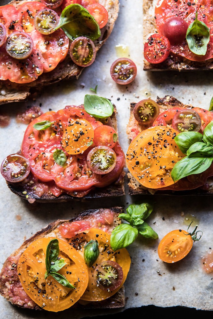 close up overhead photo of Heirloom Tomato, Basil, and Manchego Toast