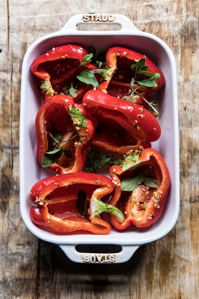 overhead photo of raw red peppers in roasting pan