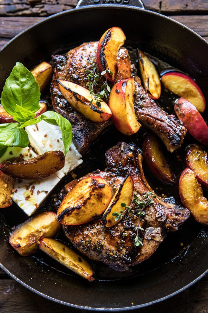 overhead photo of Skillet Balsamic Peach Pork Chops with Feta and Basil in skillet