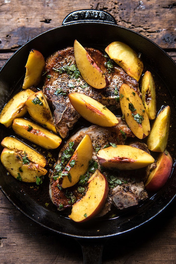 overhead photo of Skillet Balsamic Peach Pork Chops with raw peaches in skillet