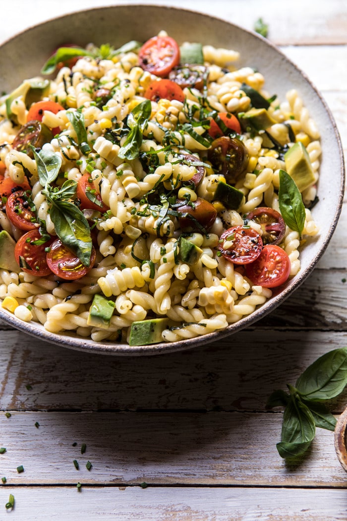 side angled photo of Corn, Tomato, and Avocado Pasta Salad