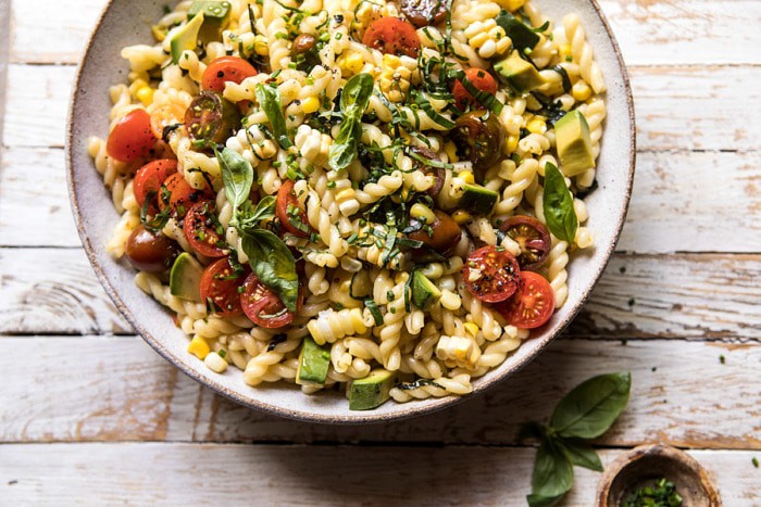 horizontal overhead photo of Corn, Tomato, and Avocado Pasta Salad