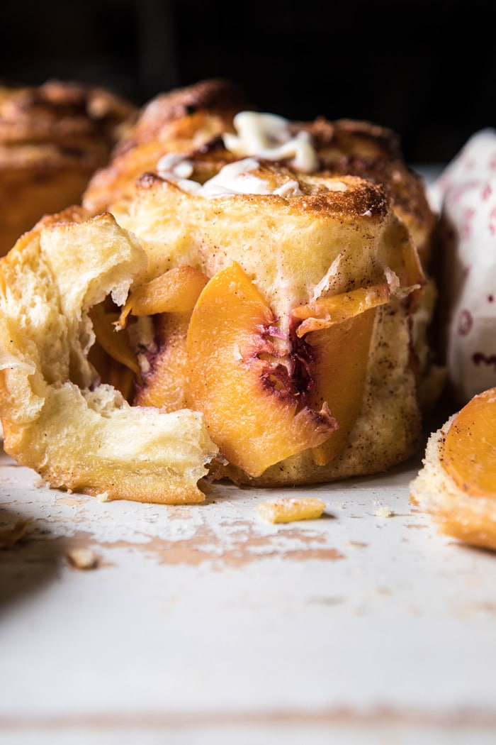 front on photo of Flaky Pull Apart Cinnamon Peach Brioche Bread torn open to expose the peaches