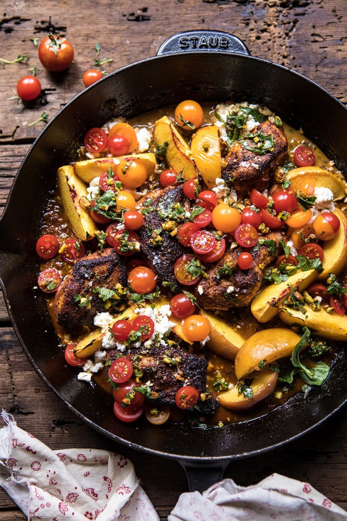 overhead photo of Skillet Moroccan Chicken with Tomatoes, Peaches, and Feta in skillet
