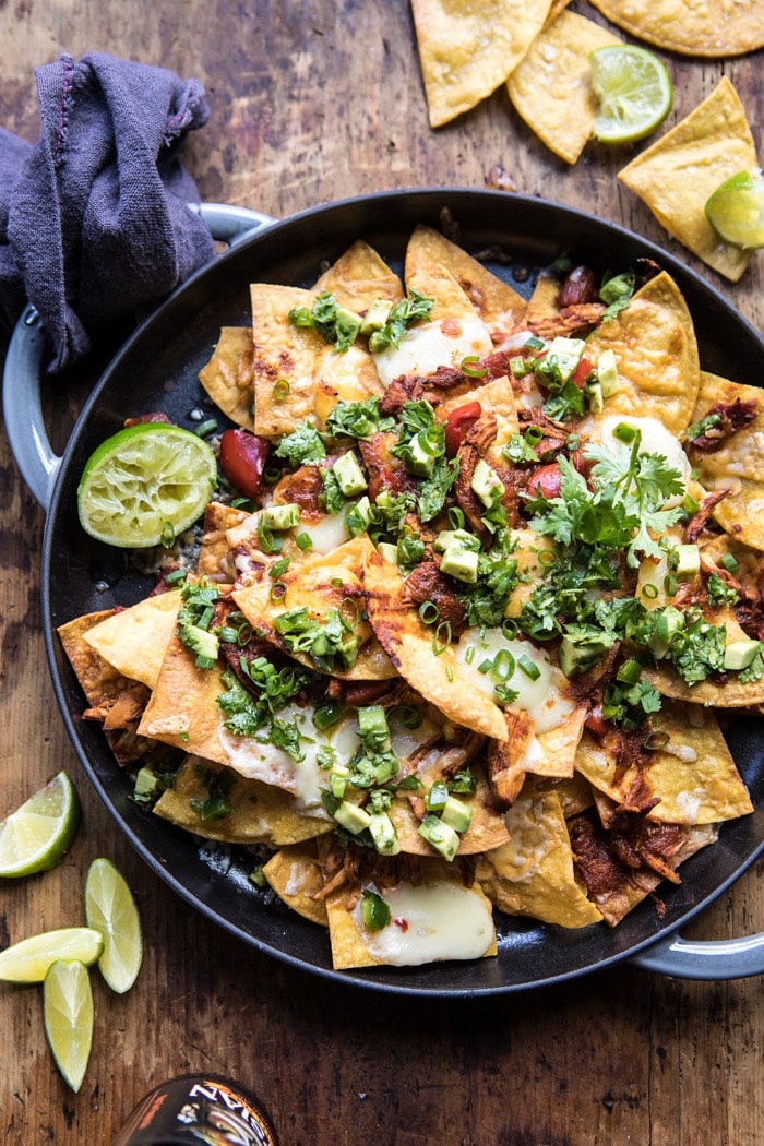 overhead photo of Chipotle Braised Chicken Nachos on plate with beer in photo 