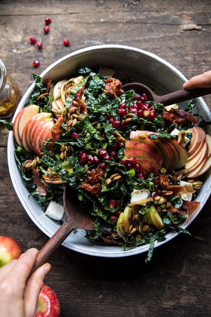 overhead photo of Fall Harvest Honeycrisp Apple and Kale Salad being tossed with salad tong