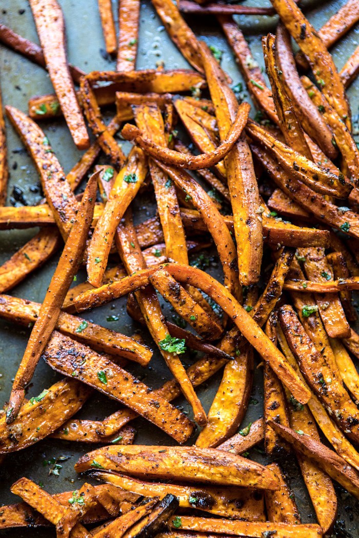 overhead photo of sweet potatoes fries on baking sheet after baking