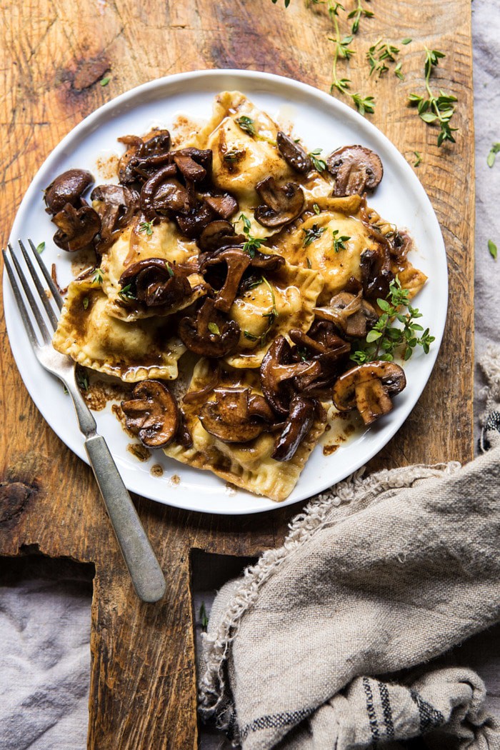 overhead photo of Herby Buttered Balsamic Mushroom Ravioli on plate with fork