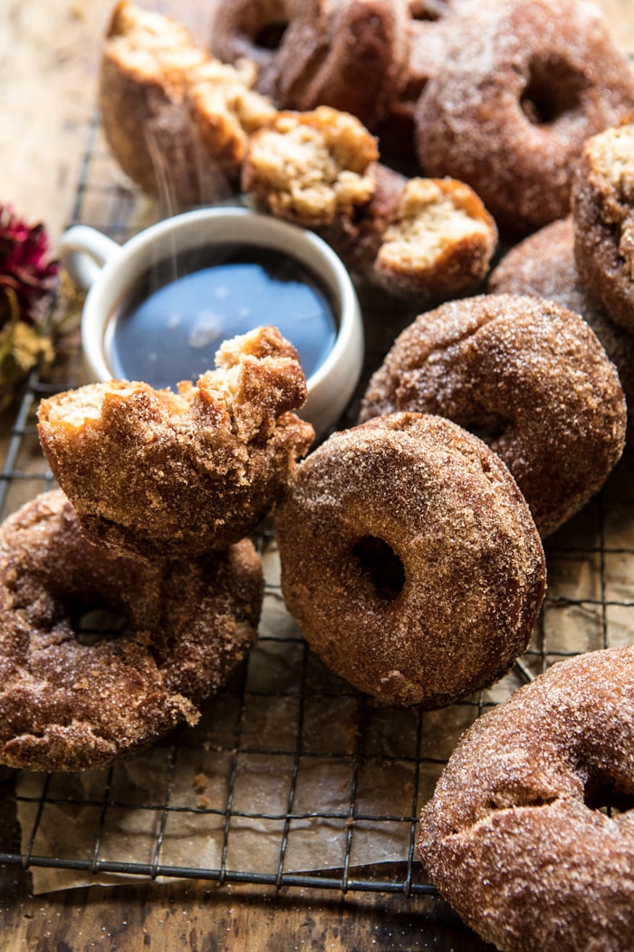 side angle photo of Mulled Spiced Apple Cider Doughnuts with steaming coffee