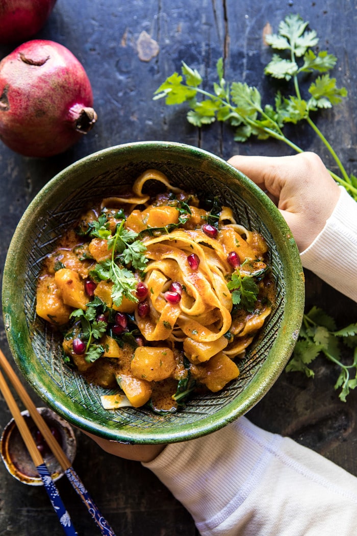 Slow Cooker Saucy Thai Butternut Squash Curry with hands holding bowl