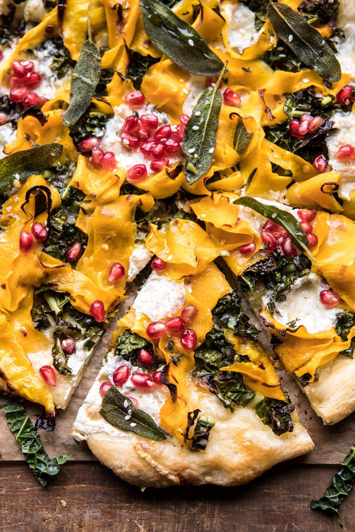 close up photo of Caramelized Onion, Butternut Squash, and Crispy Kale Pizza with piece cut out