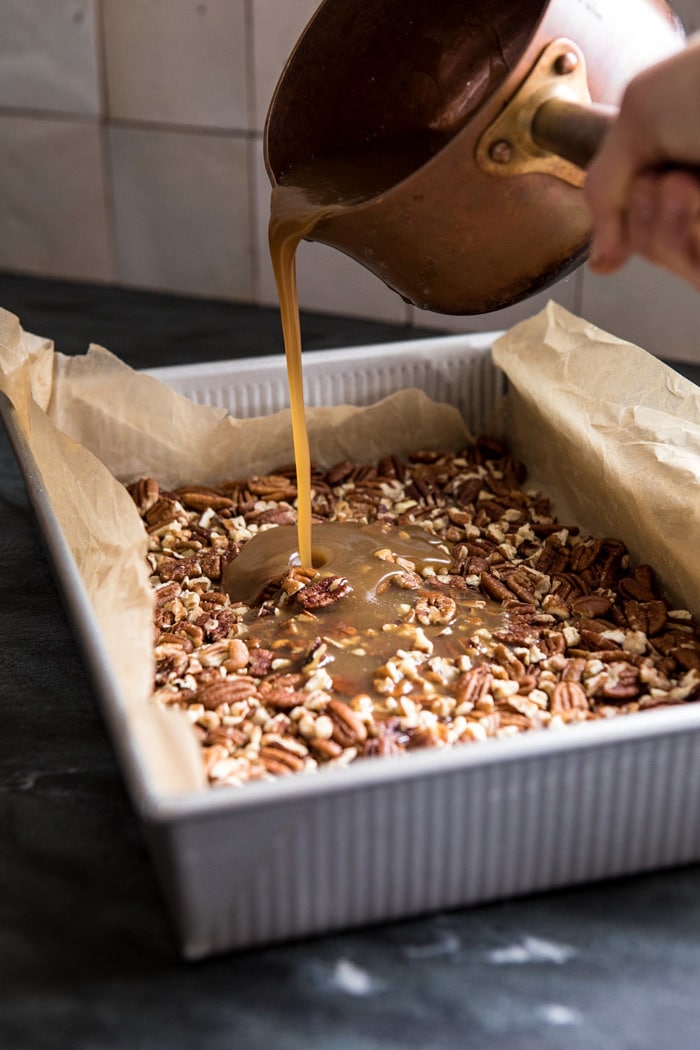 pouring sticky sauce over pecans 