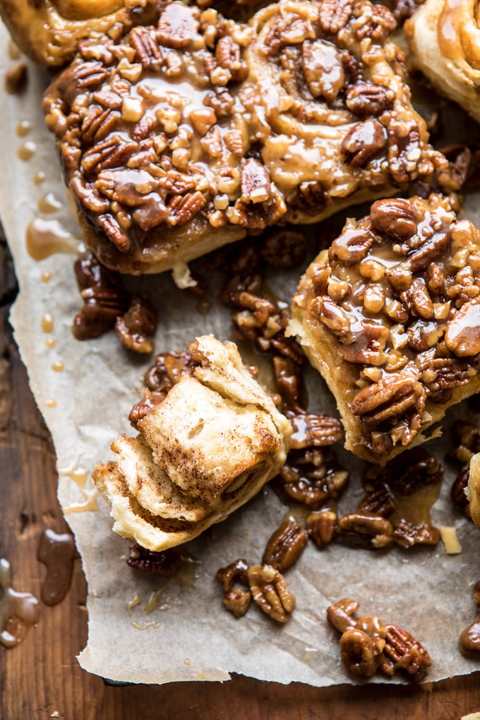 overhead photo of Extra Sticky Maple Pecan Sticky Buns with sticky bun torn in half to expose the center