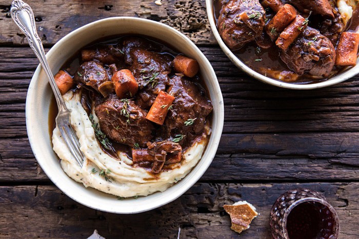 horizontal photo of Healthier Instant Pot Coq au Vin with wine glass on table