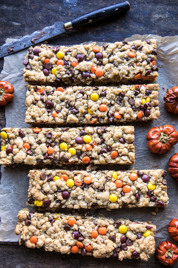 over head photo of Monster Oatmeal Chocolate Chip Cookie Bars with knife and mini pumpkin in photo