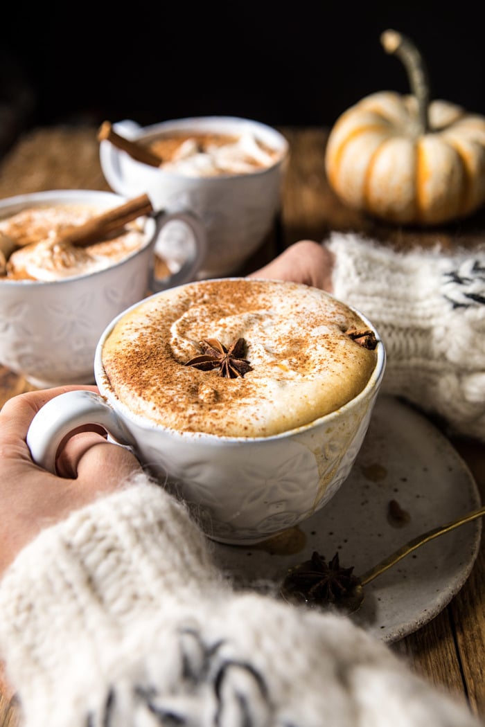 Spiced Pumpkin Maple Latte with hands on mug and 3 mugs in photo 