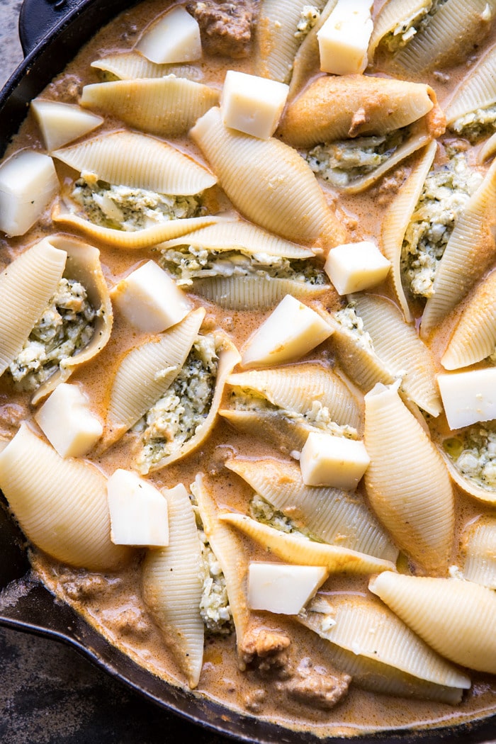 Spicy Pumpkin and Pesto Cheese Stuffed Shells in skillet before baking 