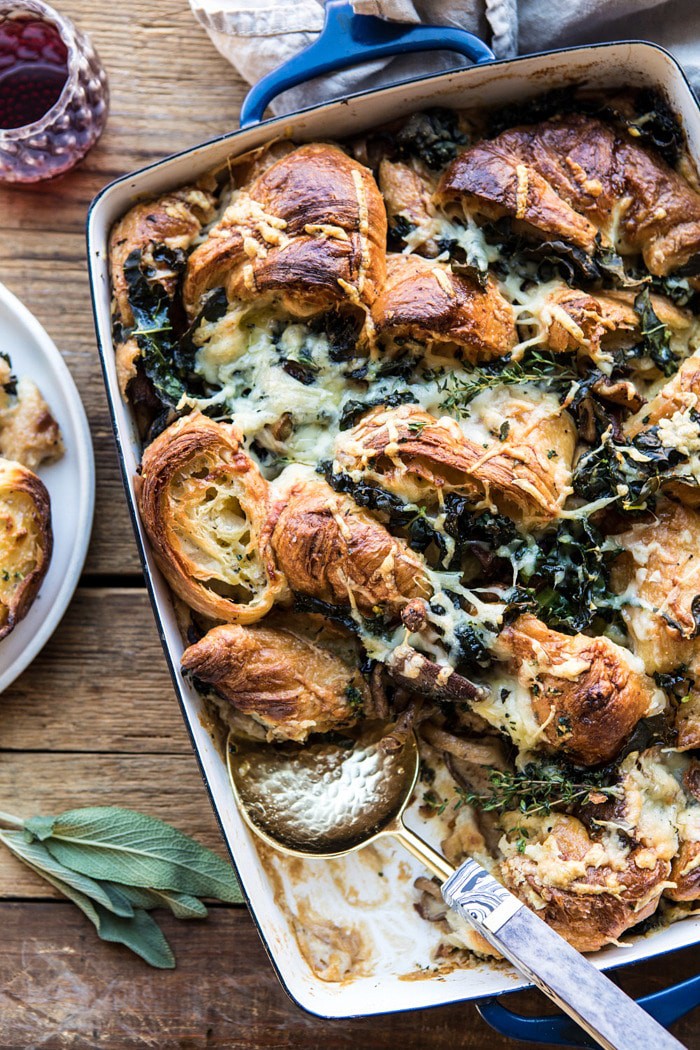 overhead photo of Herby Mushroom Croissant Stuffing with spoon in casserole 