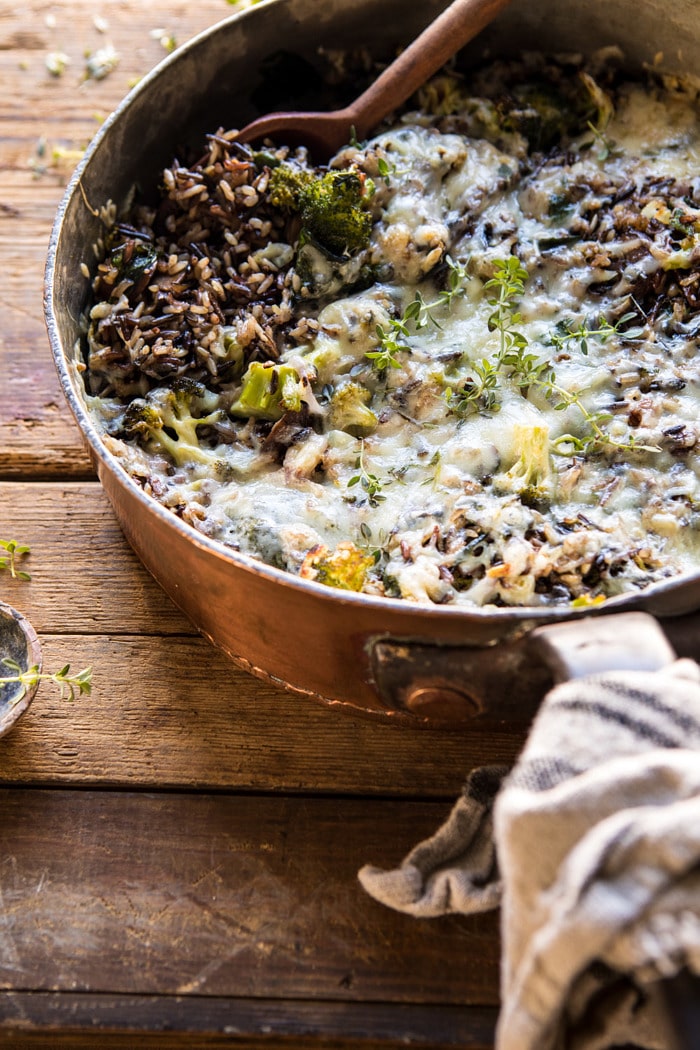 side angle photo of One Pan Broccoli Cheese Wild Rice Casserole with spoon in pan