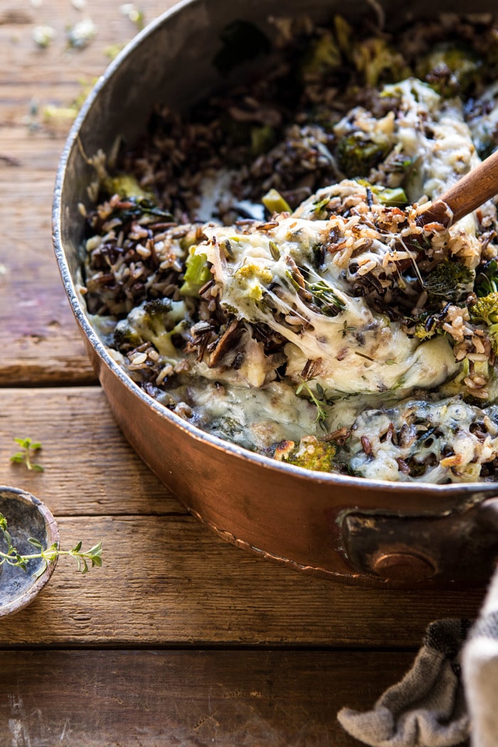 side angle photo of One Pan Broccoli Cheese Wild Rice Casserole with spoon scooping rice out of pan