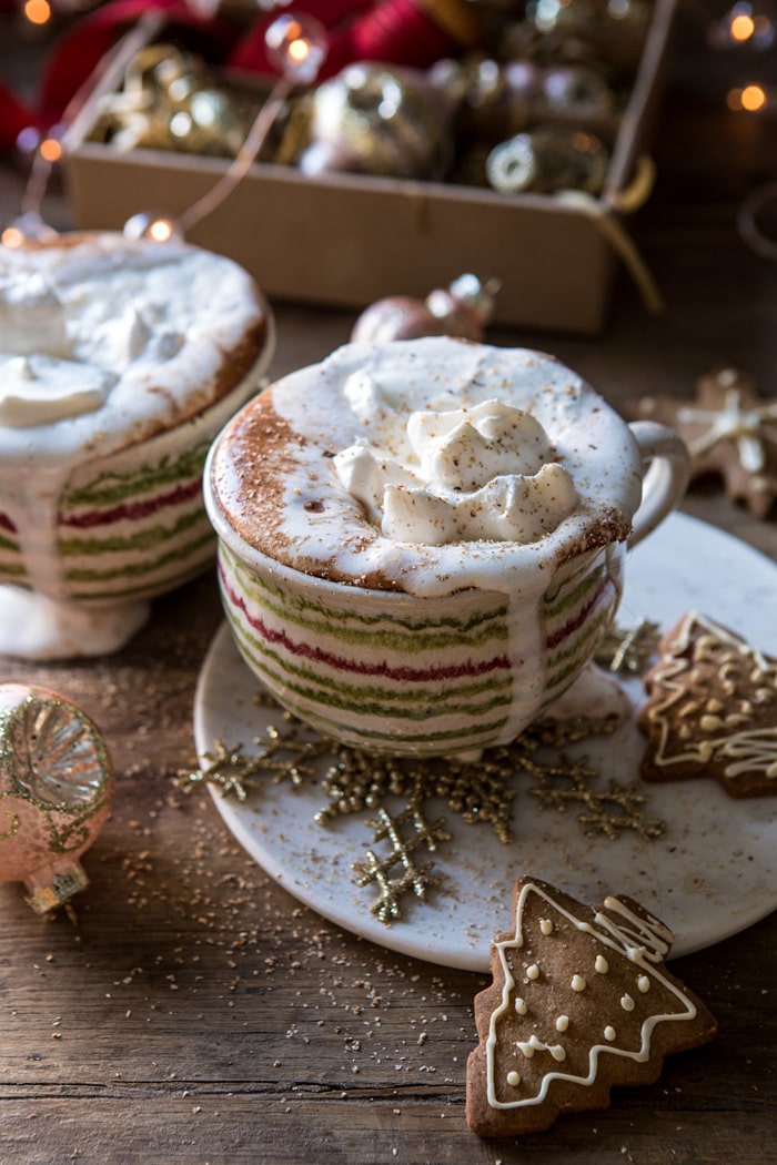 Vanilla Mocha Hot Cocoa with whipped cream dripping down the mugs