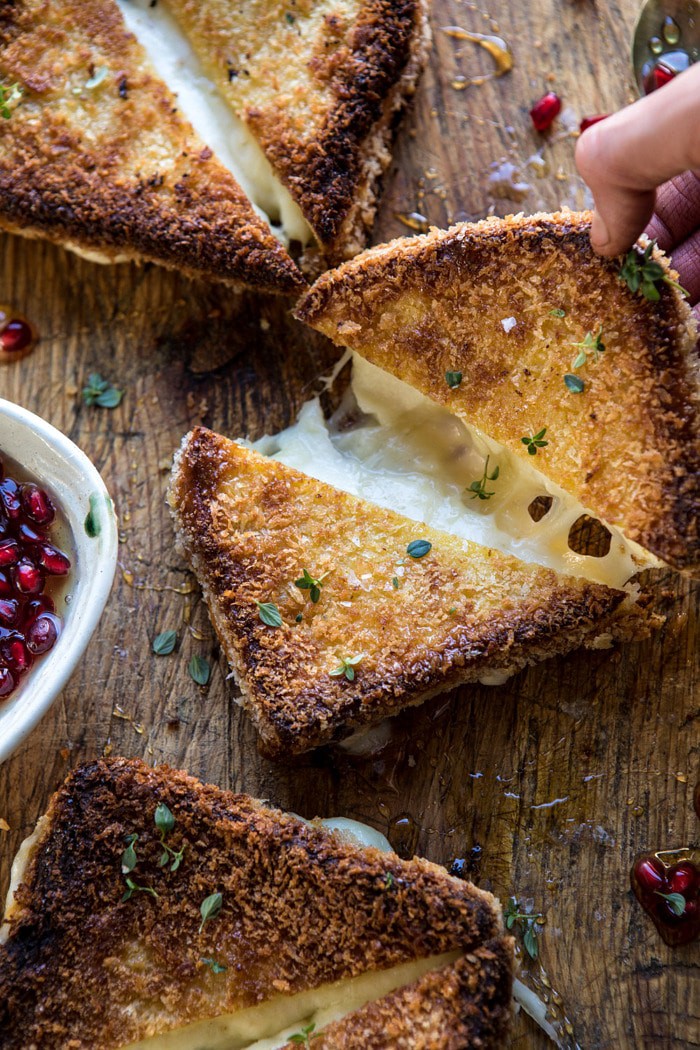 Fried Mozzarella Sandwiches with Pomegranate Honey being pulled apart 