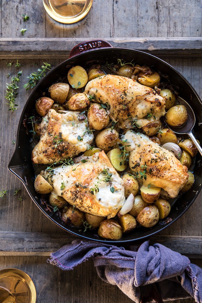 overhead photo of Skillet Roasted French Onion Chicken and Potatoes with wine on table