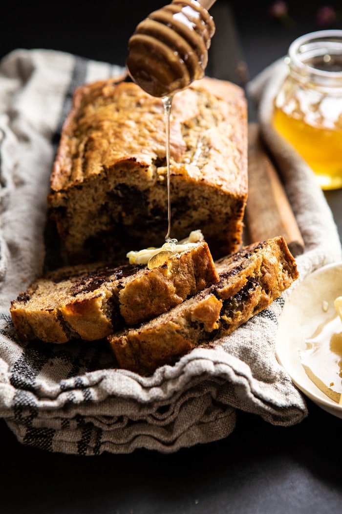 Chocolate Chunk Coconut Banana Bread with honey being drizzle on